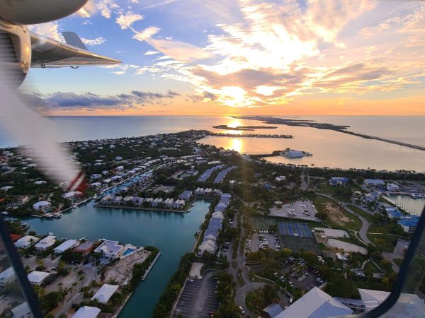 Professional aviation instructor guiding student through landing procedure safely