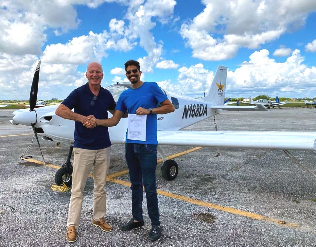 Flight instructor guiding beginner pilot at Dynasty Aviation Pembroke Pines
